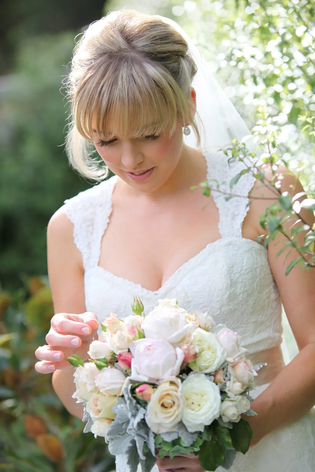 Bride looking down at her bouquet