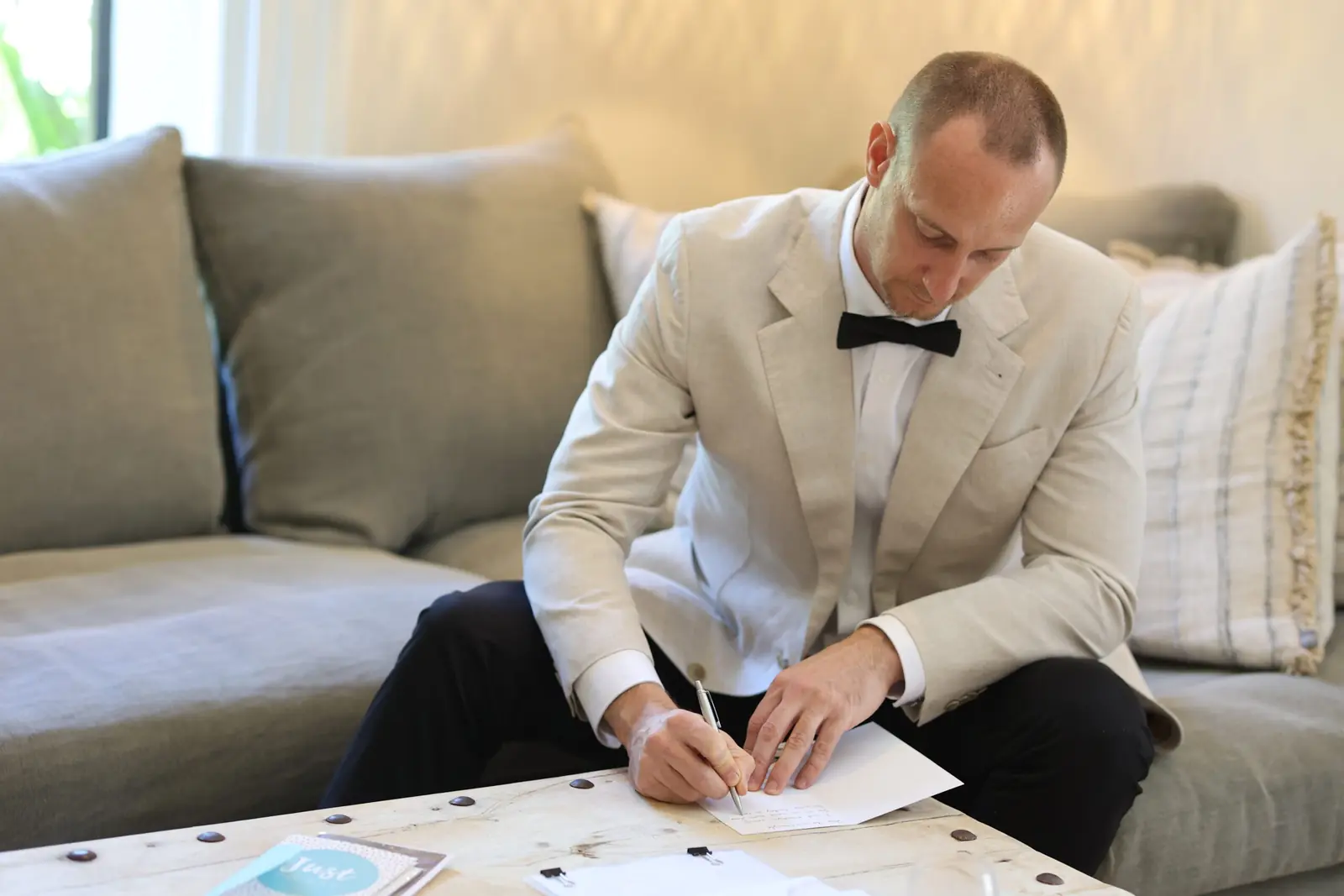 Groom writing a letter on his wedding morning