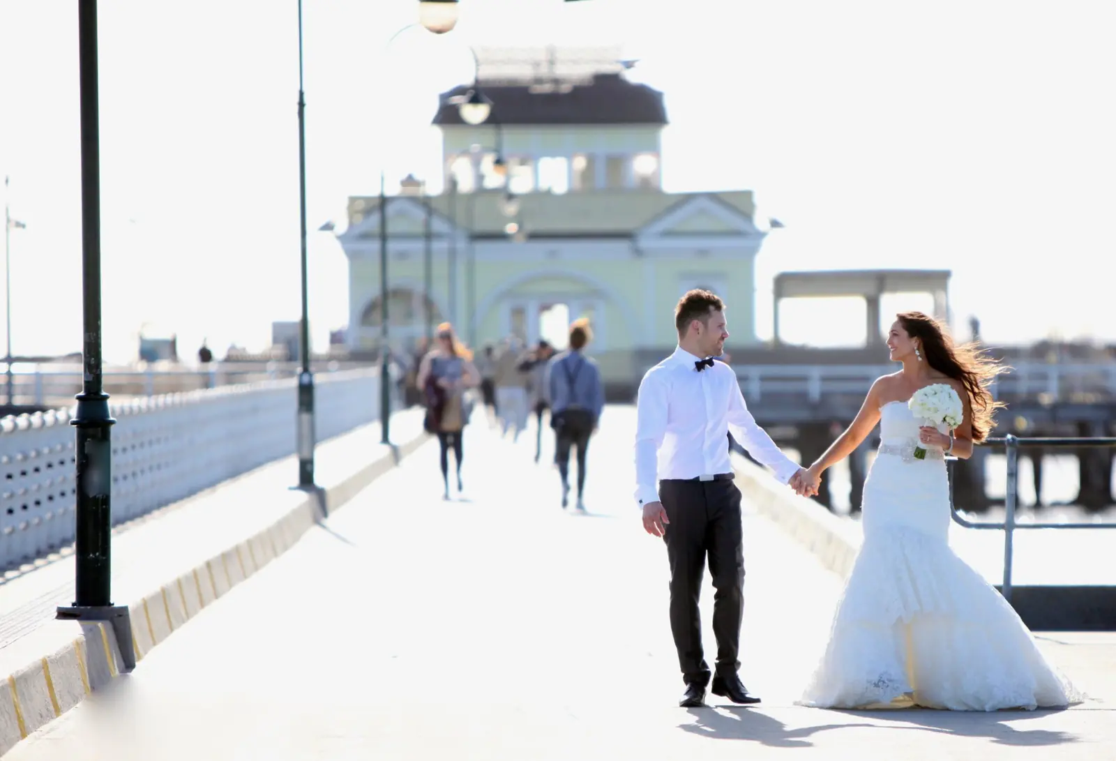 Couple walking along a pier